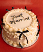 Black Bows Just Married Wedding Cake