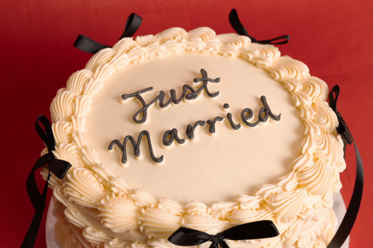 Black Bows Just Married Wedding Cake